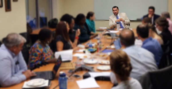 Picture of a board of directors meeting around a table.