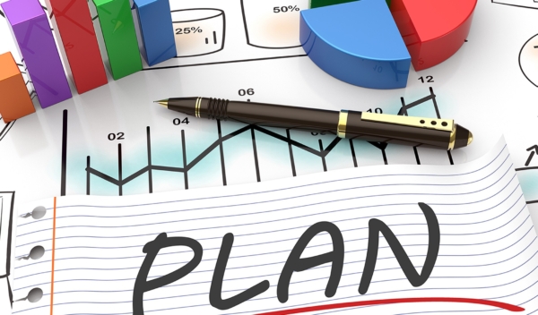 Plan written on paper with a graphs around it