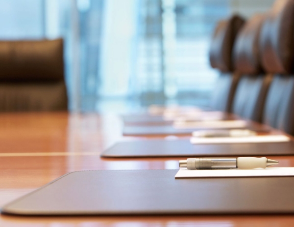 Picture of board room and chairs around the table.