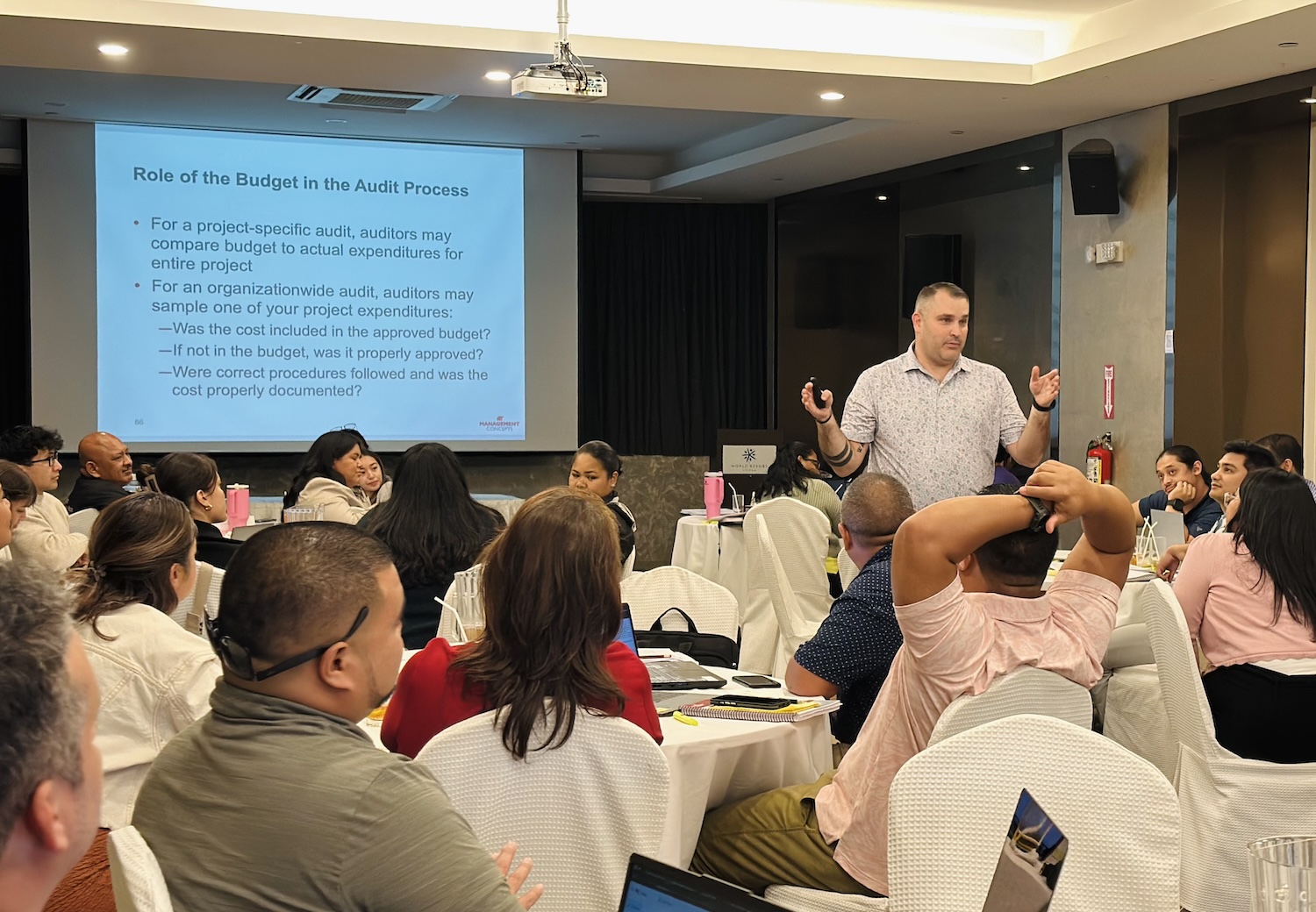 Dave leading a training about grants management in front of a large group.