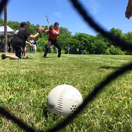 Photograph of people playing Beep Baseball, an adaptive game of baseball designed for people who have low to no vision