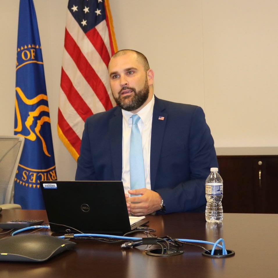 Picture of Dave sitting behind a desk.