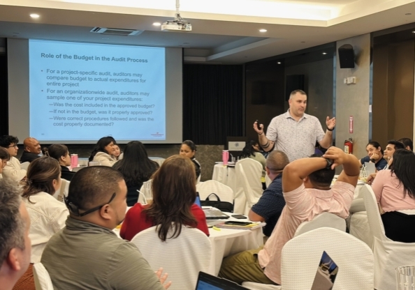 Dave leading a training about grants management in front of a large group.